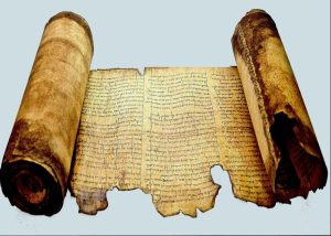 Close-up of an ancient Bible manuscript illuminated by warm light, symbolizing the unity of Scripture and the Covenant of Grace.